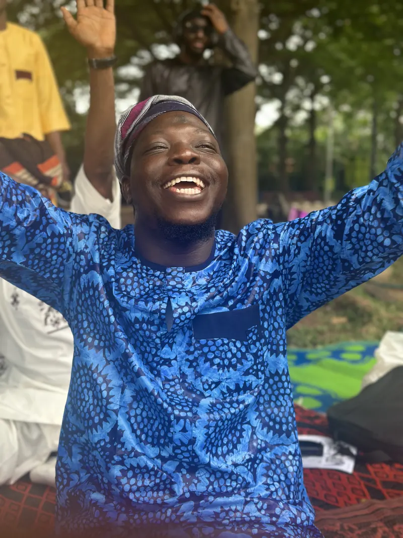 A joyful attendee with arms raised